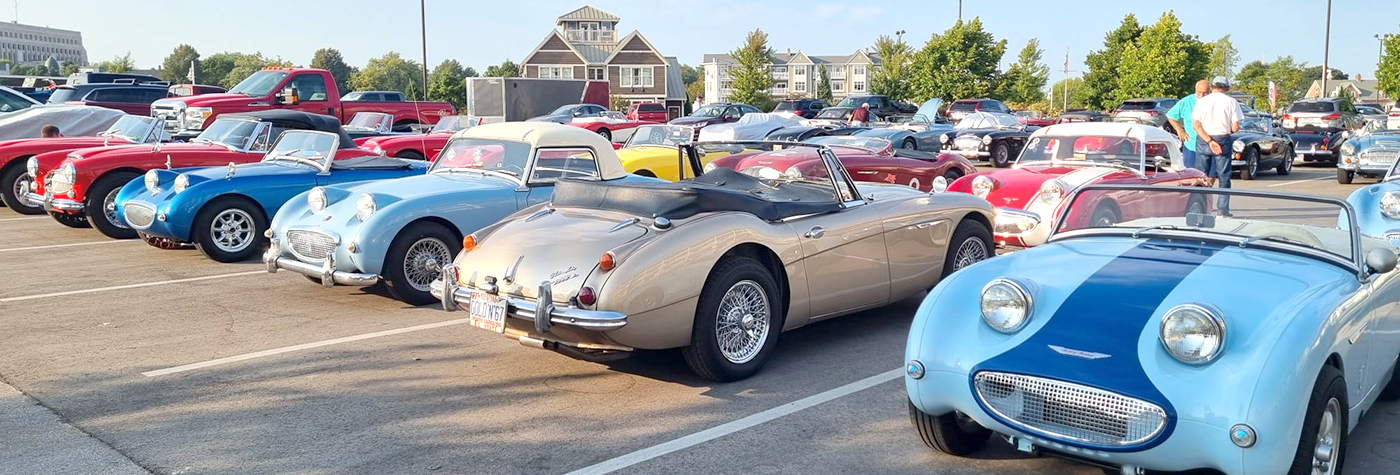 Austin Healey and Sprite cars parked in a row at the Conclave 2024 event in the US