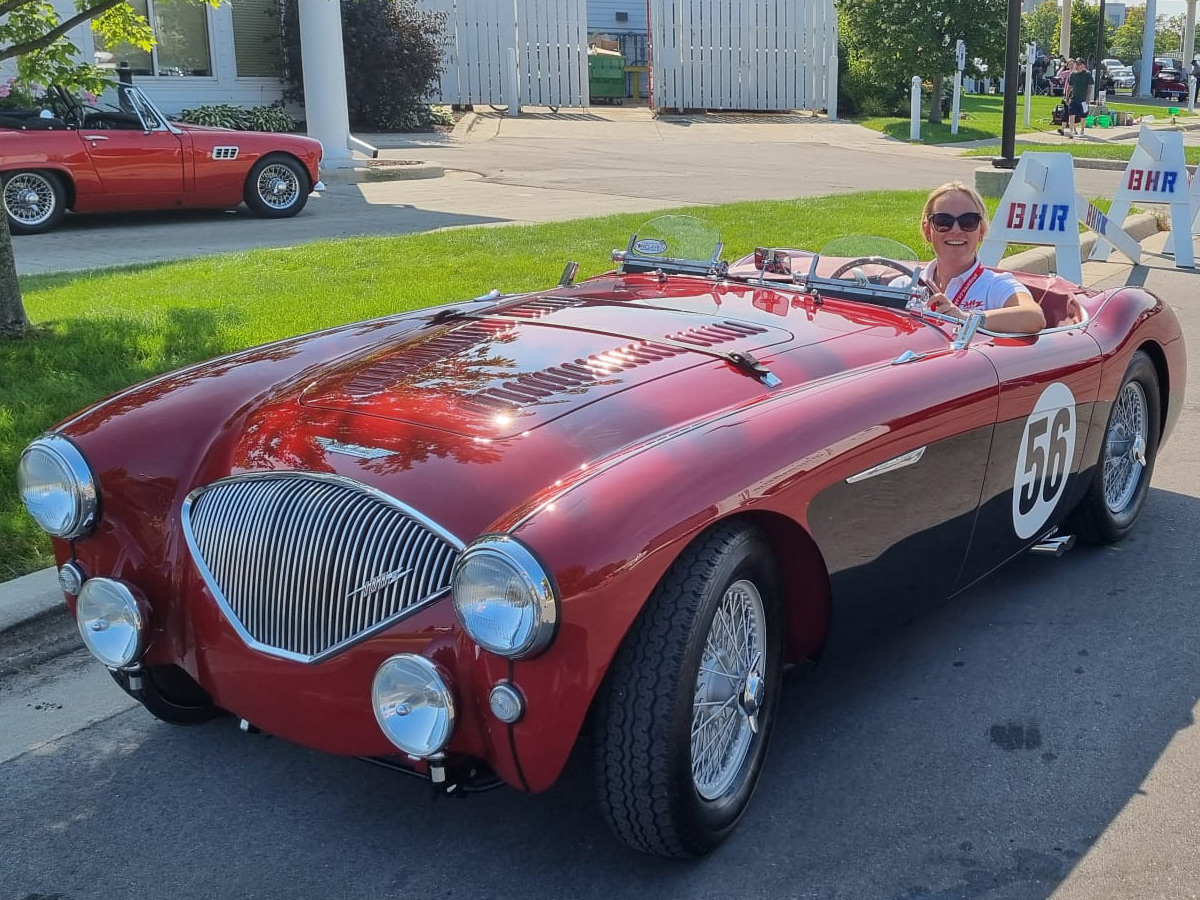 Rebecca sitting in Ken Sierszen's Austin Healey 100M 