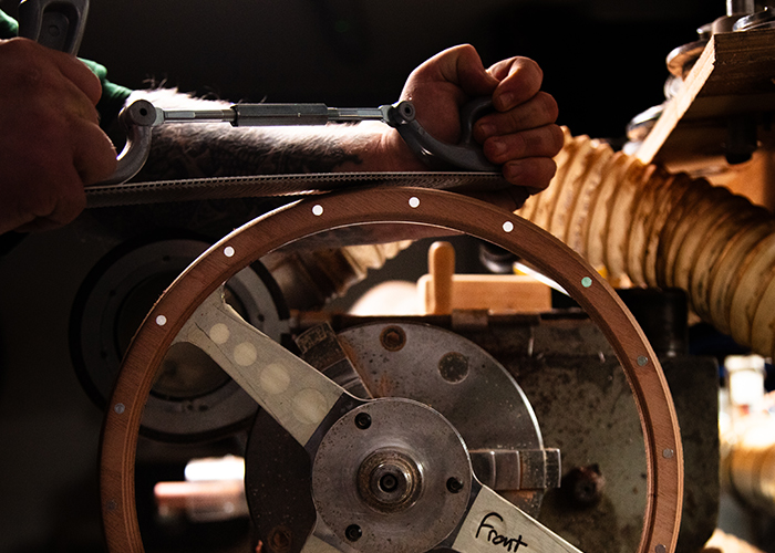 Final sanding on the wood grip of a Moto-Lita steering wheel